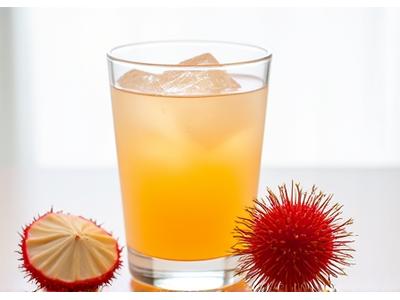 Segelas jus rambutan jernih dengan beberapa biji rambutan di pinggir gelas.